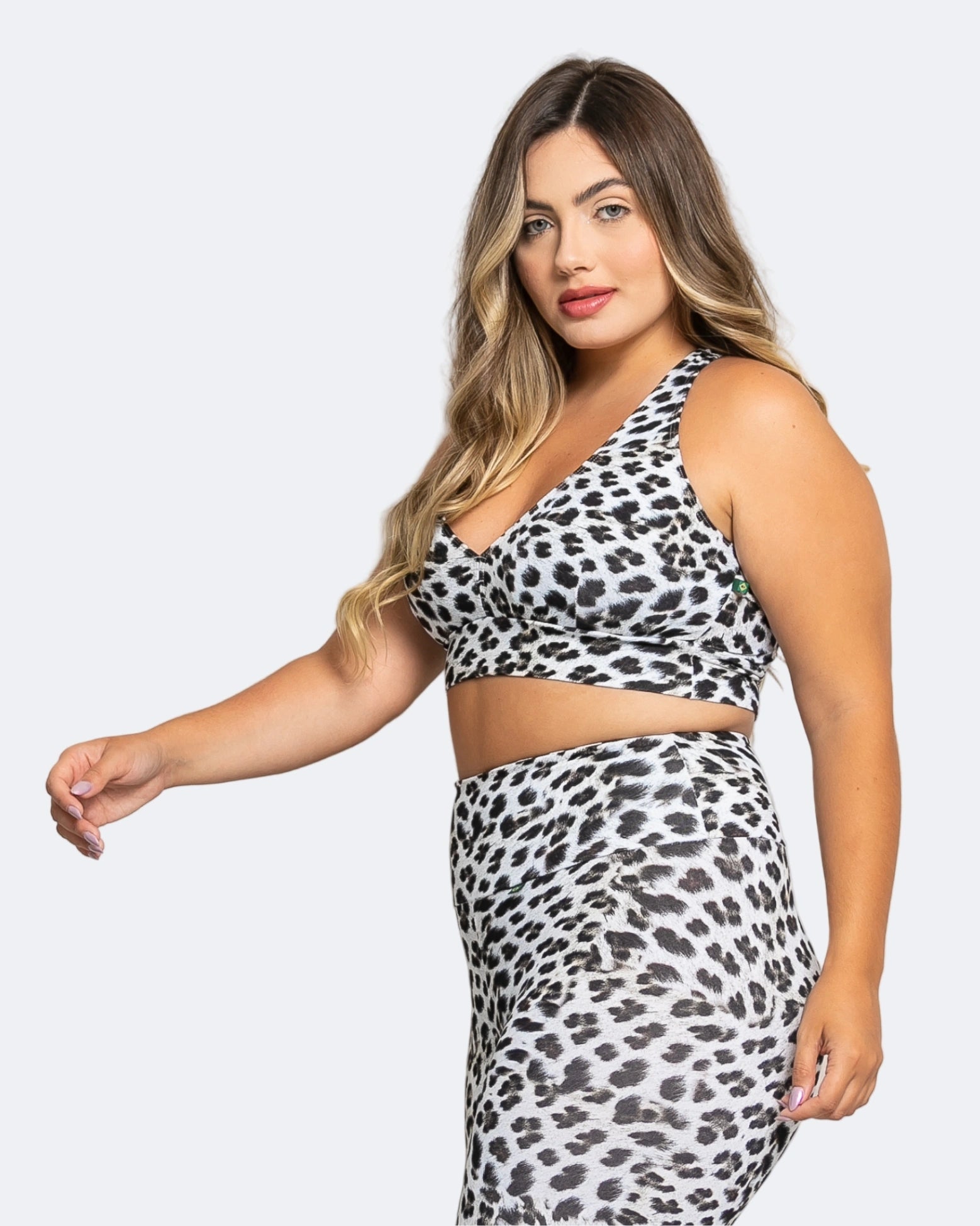 Woman wearing a leopard print two-piece outfit on a white background