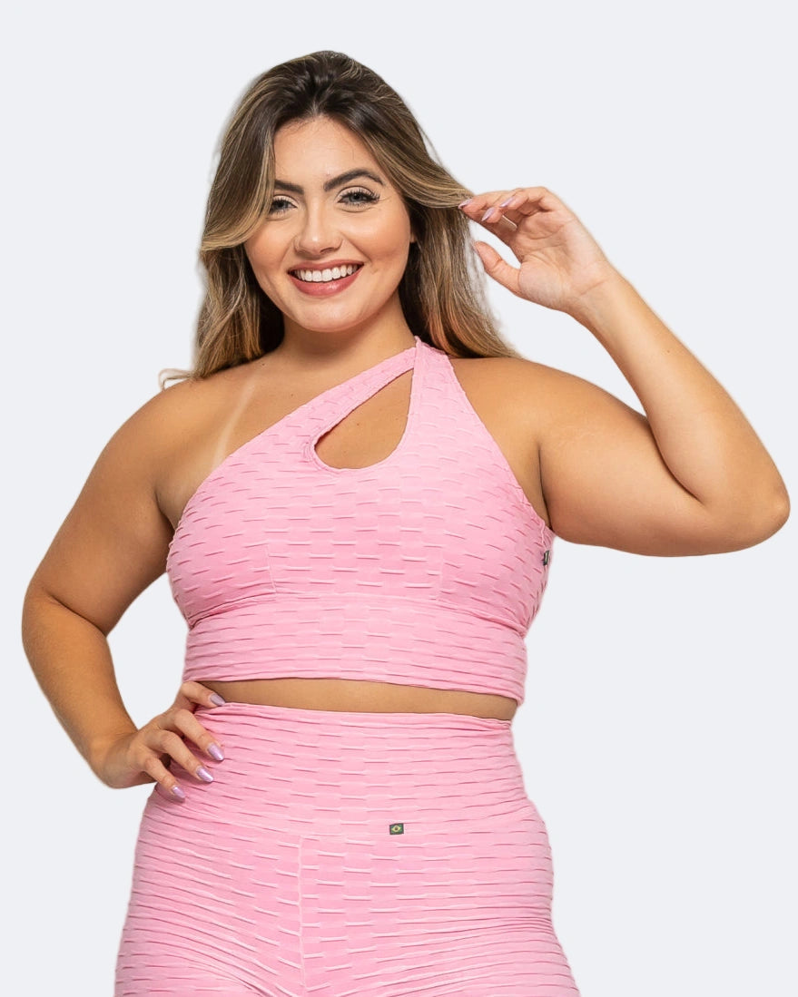 Woman wearing a pink athletic outfit on a white background