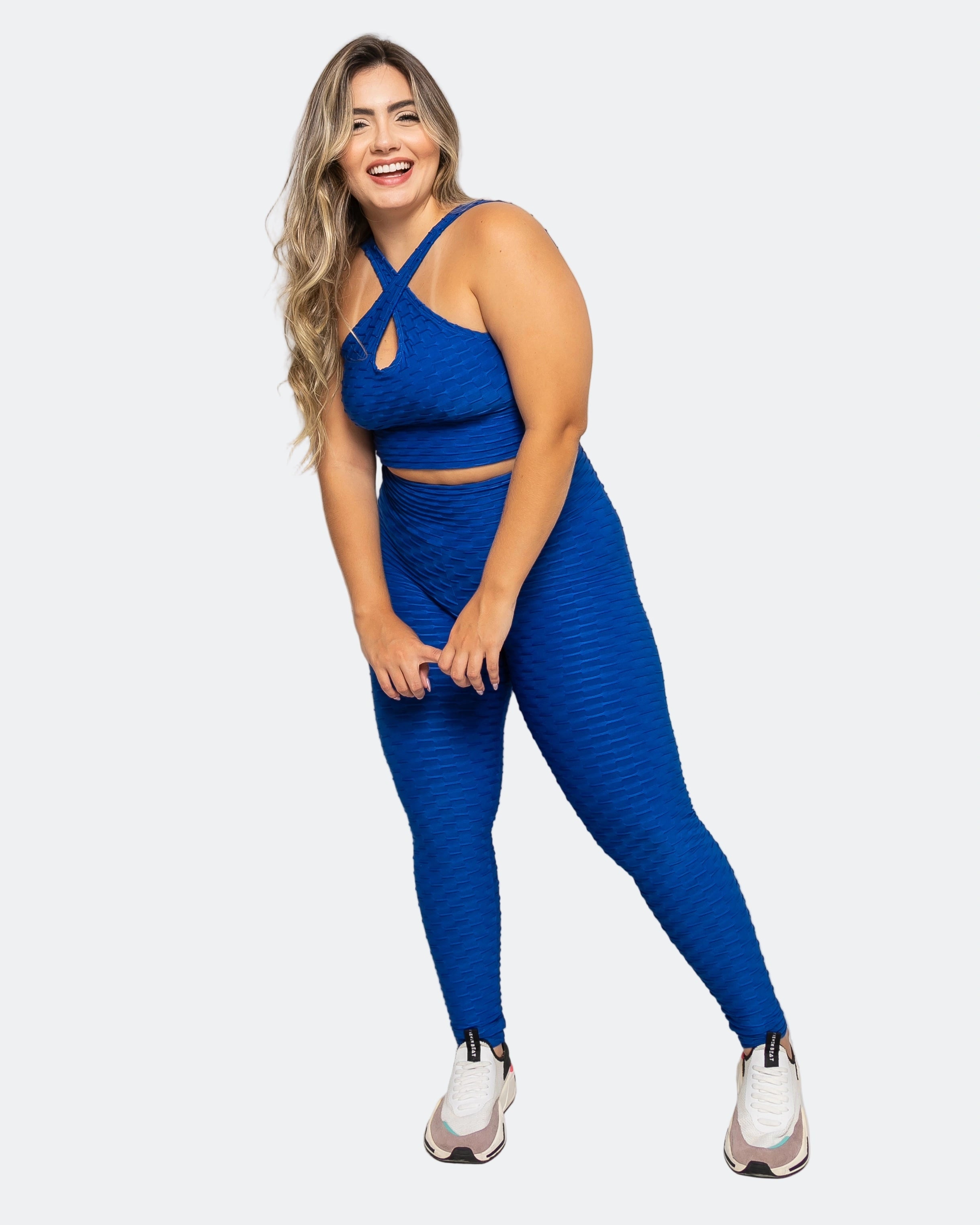 Woman wearing a blue athletic outfit on a white background