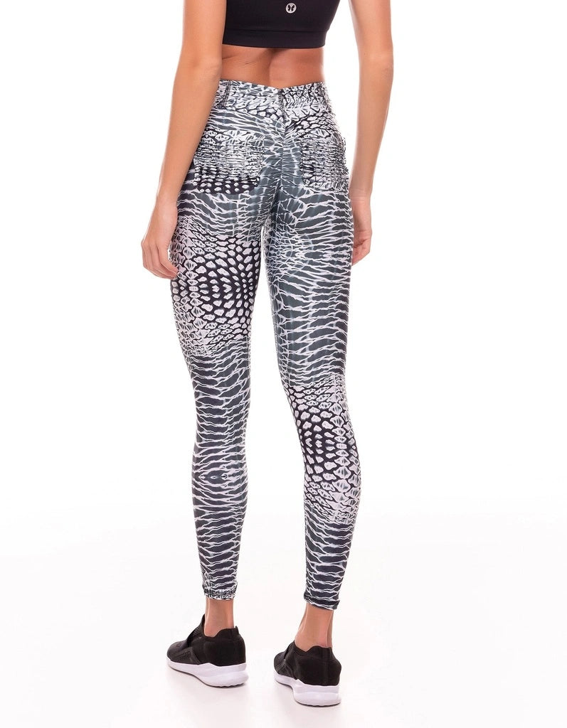 Person wearing patterned leggings on a white background