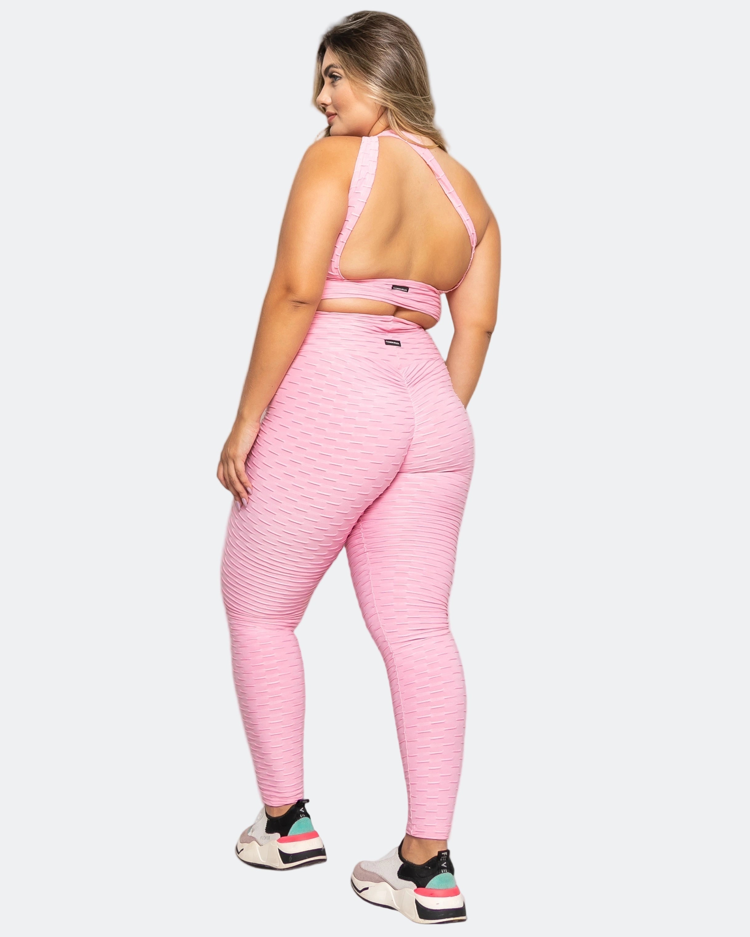 Person wearing a pink sports outfit on a white background