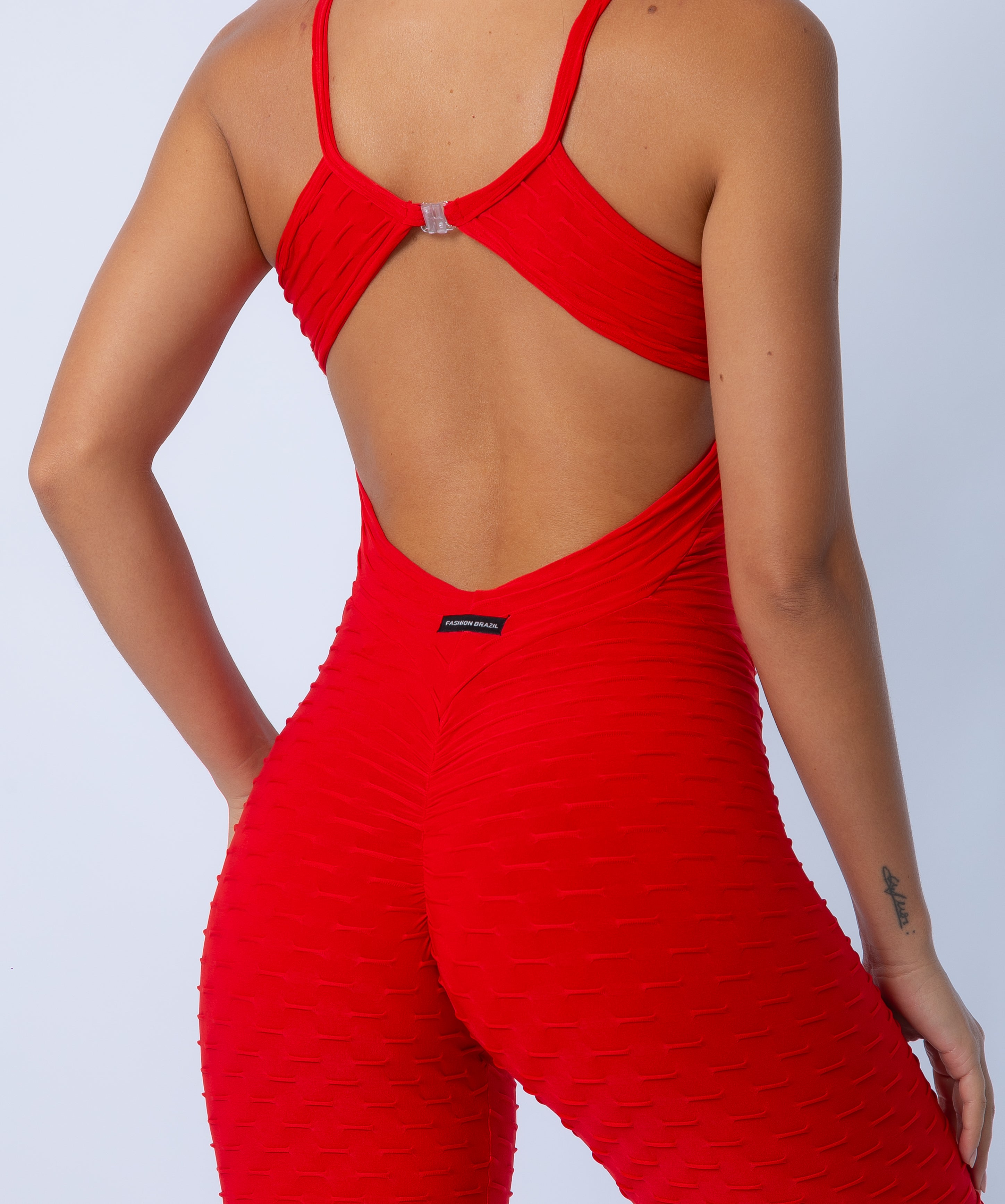 Fashion Brazil Amelia Red Jumpsuit, close-up back view highlighting scrunch-back seam detail, curve-enhancing butt-lift design, and Zero Flaws textured fabric.