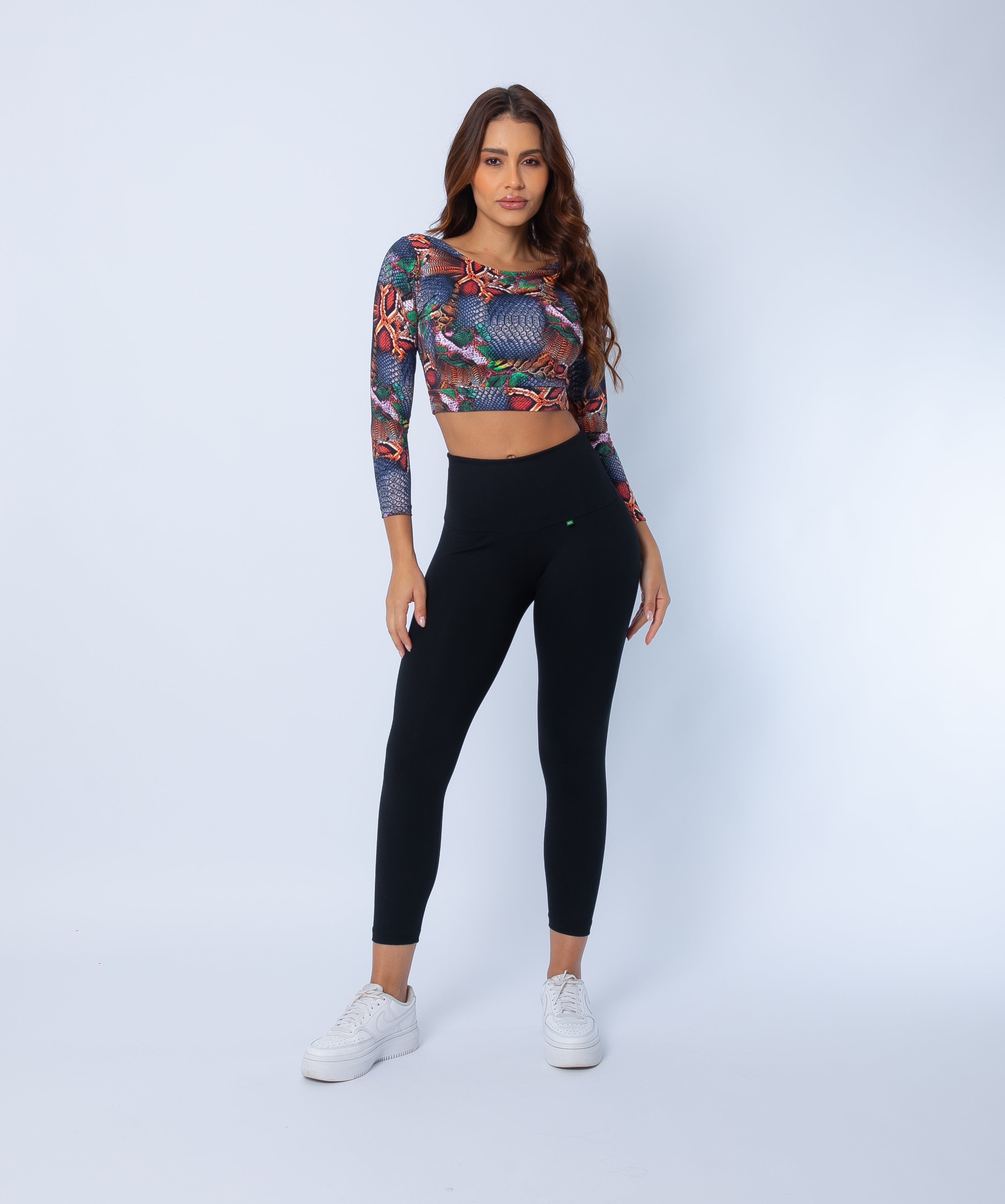 Fashion Brazil Copper Cobra Long Sleeve Crop Top, front view paired with Black Sculpt 7/8 Leggings, showing sculpting fit, snakeskin print, and sleek high-waisted silhouette.