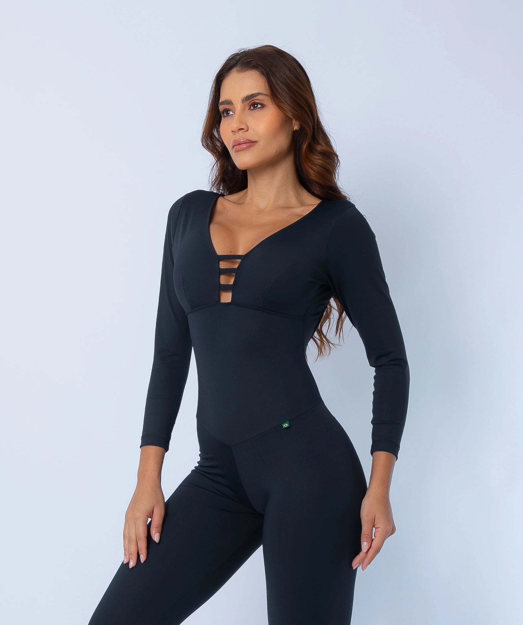 close-up of Fashion Brazil Elevate Long Sleeve Jumpsuit front neckline, showing bold strappy V-neck design and smooth compression fabric.