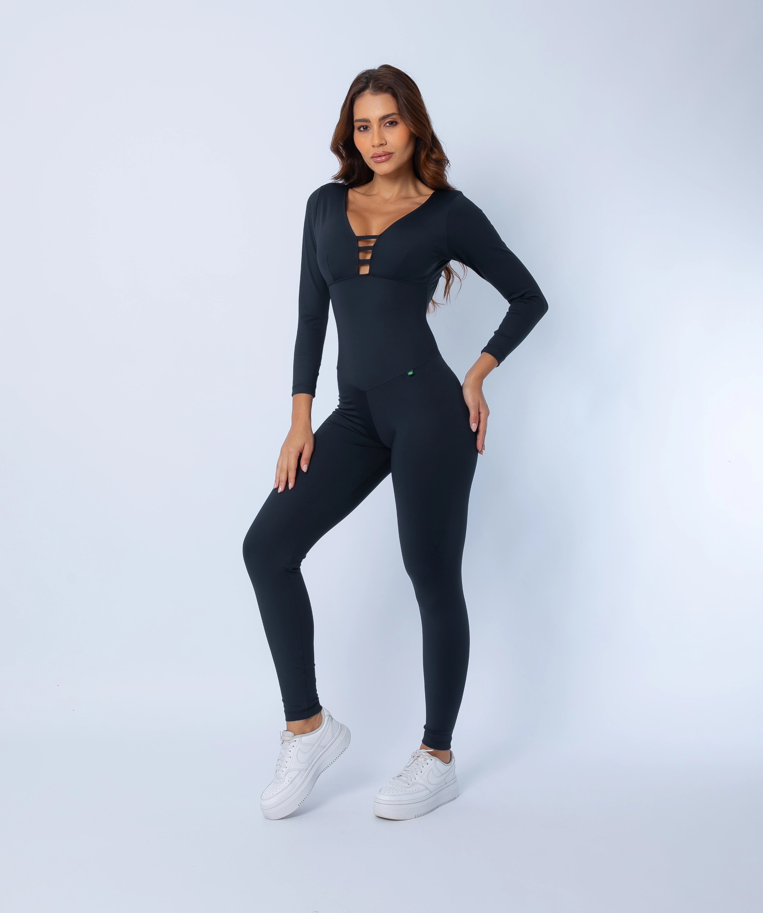 Fashion Brazil Elevate Long Sleeve Jumpsuit side view, showing body-sculpting compression fit, long sleeves, and streamlined silhouette.