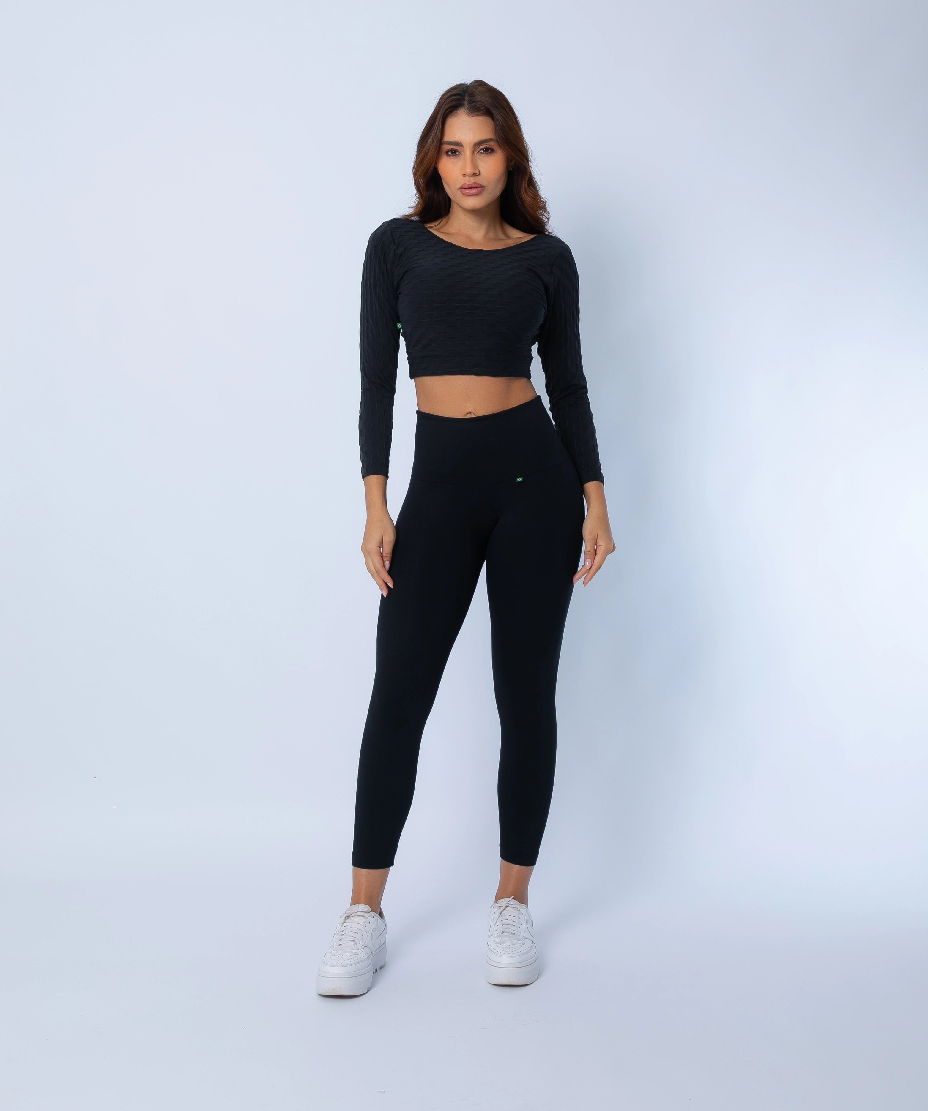Sculpt high compression 7/8 Leggings and  Long Sleeve Crop Top, side view highlighting curve-hugging fit and supportive high-rise waistband with matching crop top.