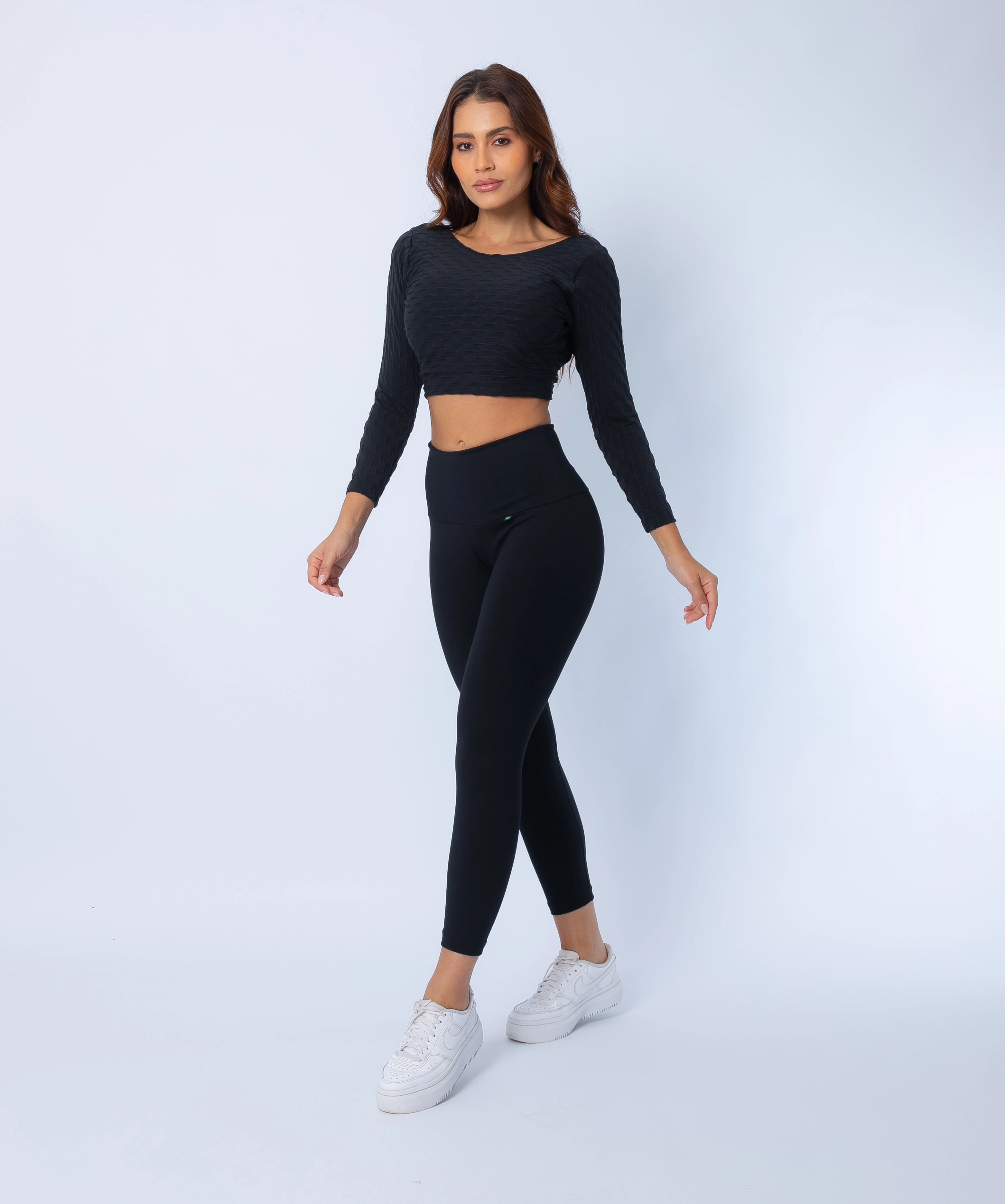 Sculpt high compression 7/8 Leggings and  Long Sleeve Crop Top, side view highlighting curve-hugging fit and supportive high-rise waistband with matching crop top.