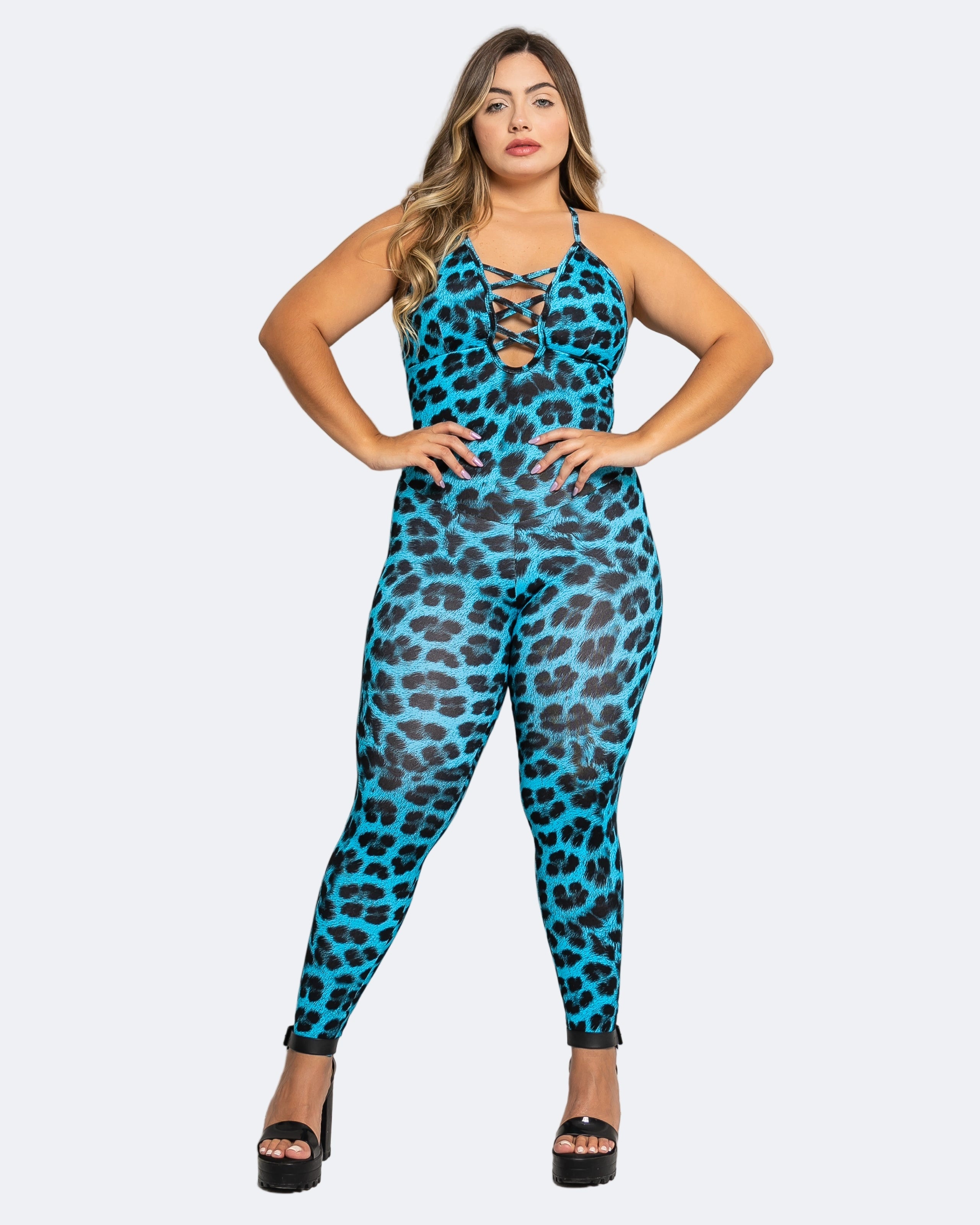 Woman wearing a blue leopard print jumpsuit against a light gray background