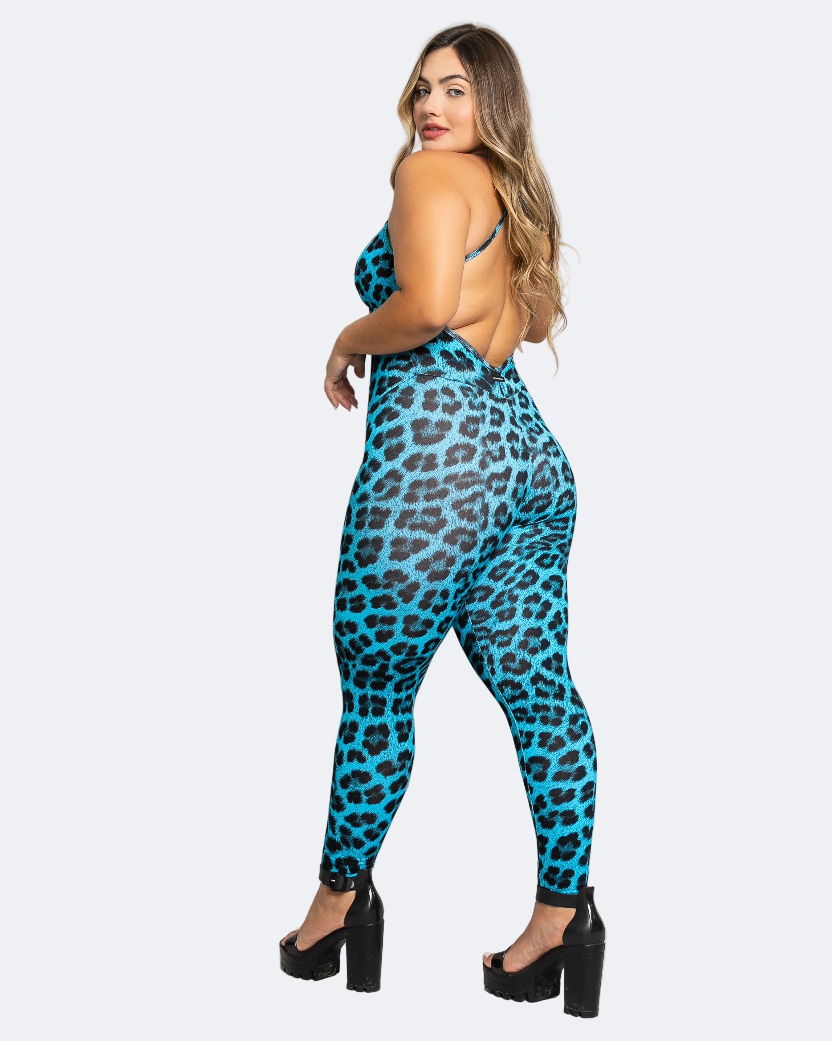 Woman wearing a blue leopard print jumpsuit on a white background