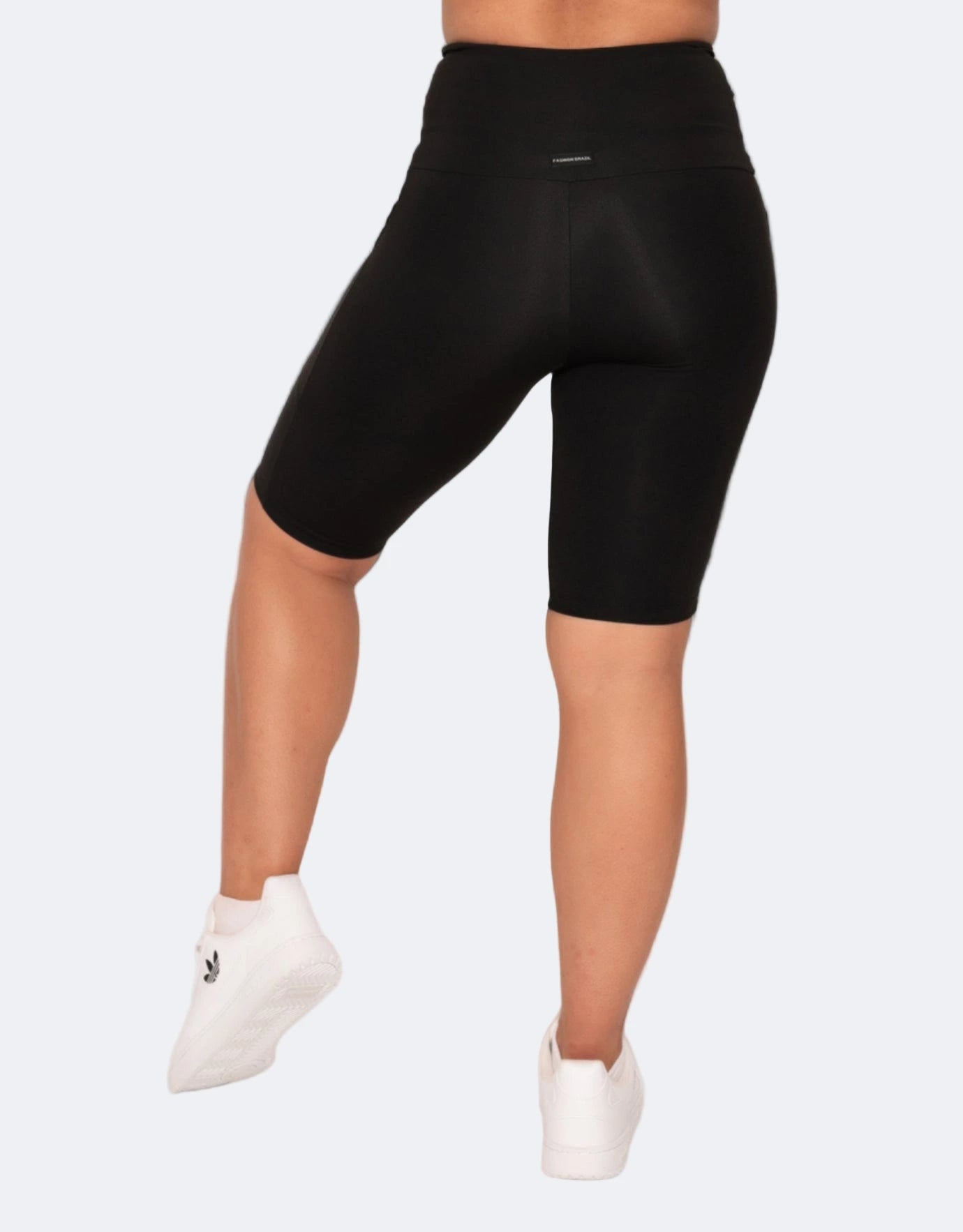 Close up of black bike shorts with pocked  on a white background