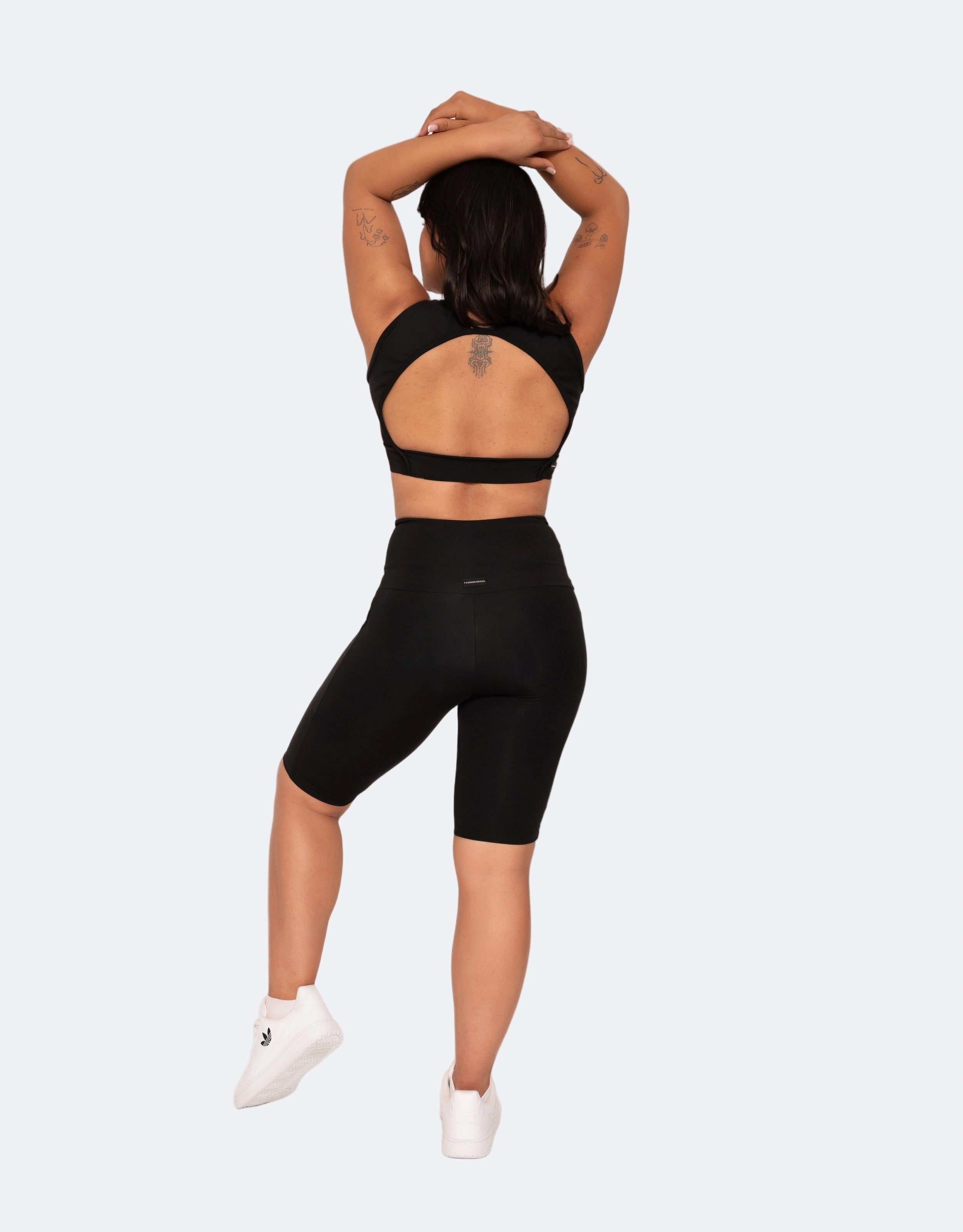 Person wearing a black athletic outfit on a white background