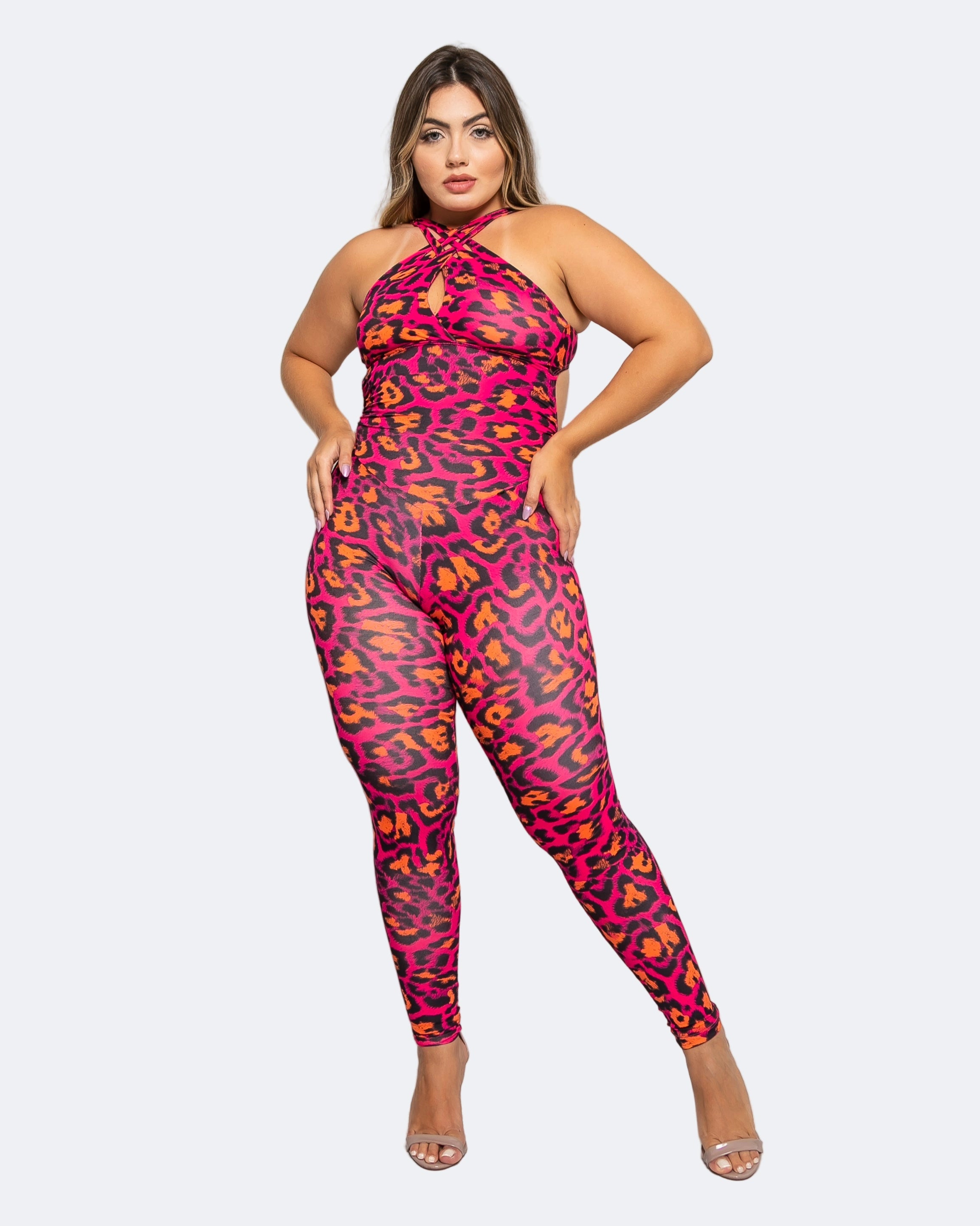 A model wearing a pink leopard print full-length jumpsuit with a medium-high waistband, designed for dancewear and performance.