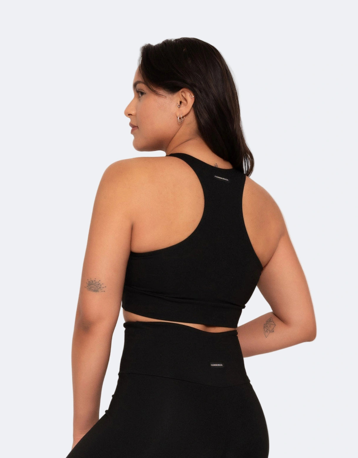 Model wears black sports bra  with  racerback on a white background