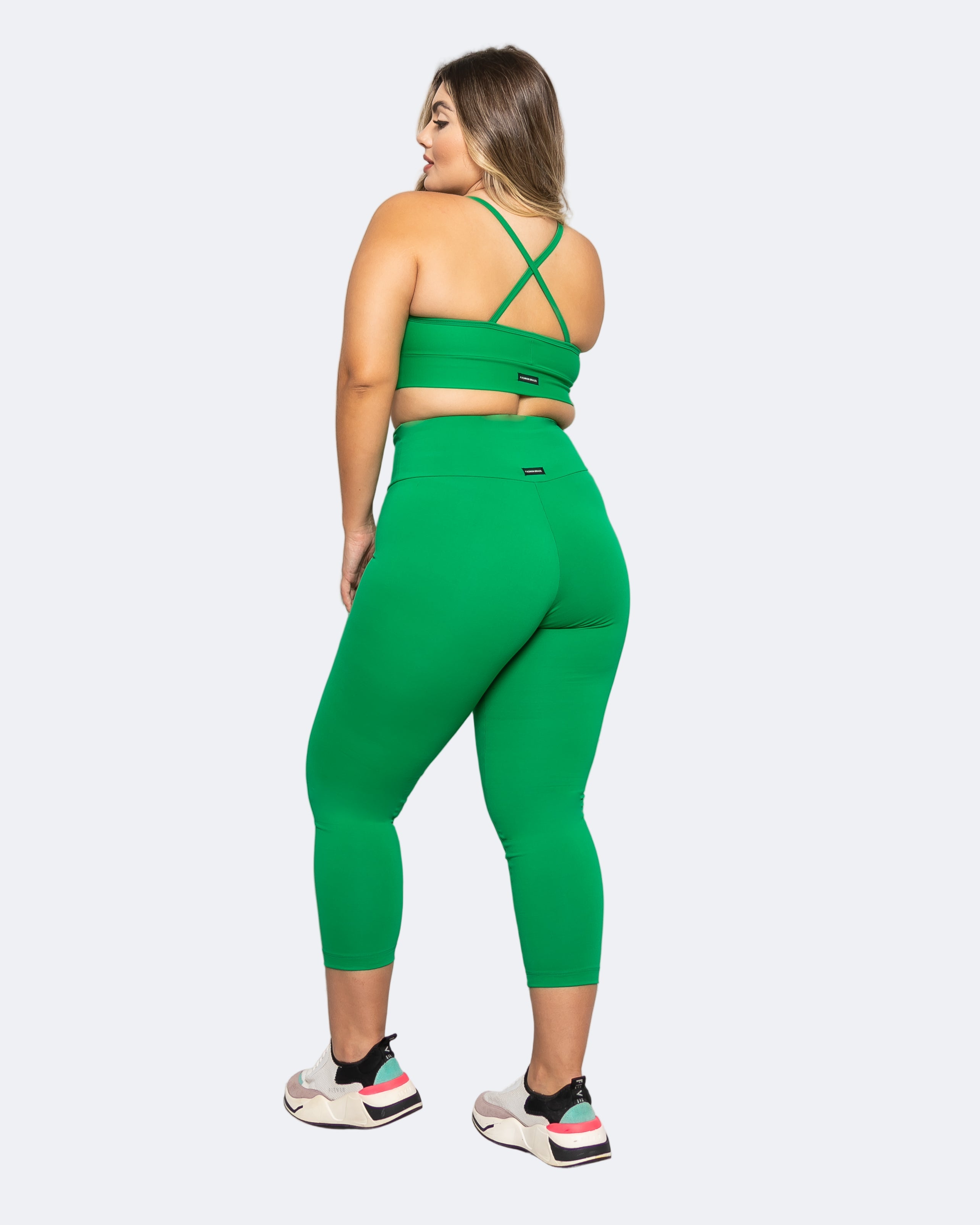 Person wearing a green sports outfit on a white background